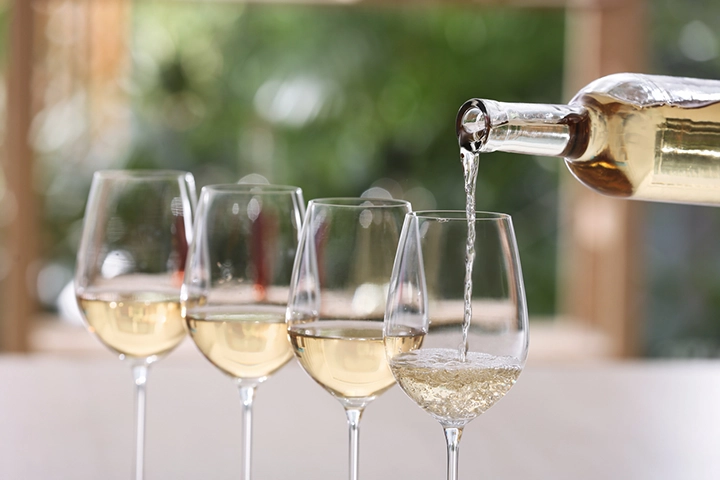 White wine being poured into glass.