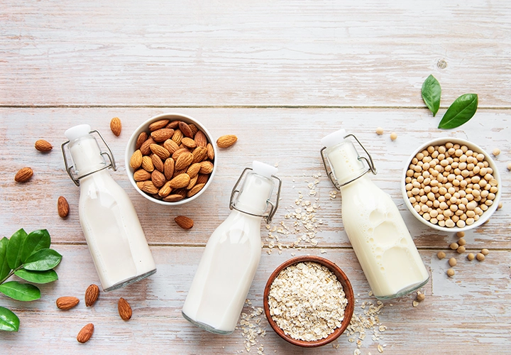 Milk, nuts and oats on a wooden table