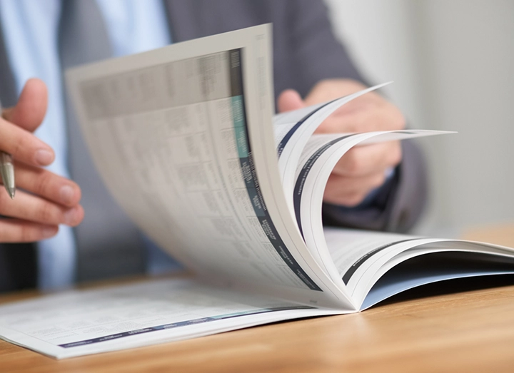 Man reviewing the paper annual report